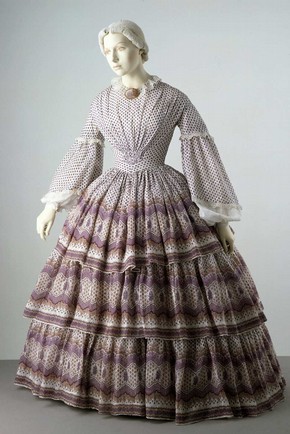 Dress with a pattern that complements the shape created by the cage crinoline worn underneath it. Museum no. T.702-1913