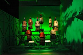 Figure 4 – The tiered display of nine 'Rite of Spring' costumes. A one metre distance barrier designed as integral part of the display protects objects without drawing attention to its physicality. Photograph by Bhavesh Shah