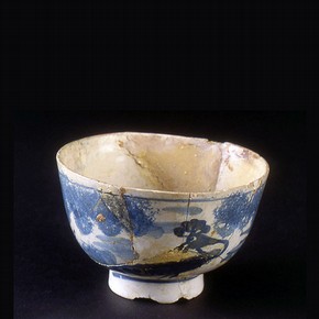 A poorly repaired English tin glazed earthenware bowl, late-17th to mid-18th century.