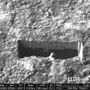 Figure 5. A Secondary Ion (SIM) image of the ion beam milled trench, viewed at a 45° tilt, showing the patinated layer on top of the metal. 