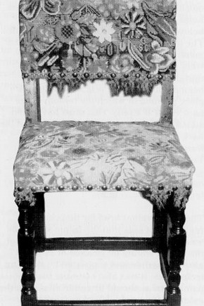 Fig 3. The chair before conservation. A large area of the pattern at the front of the seat has been painted onto the backing