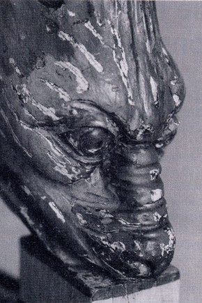 Figure 2. Before conservation, detail showing the paint losses on the dolphin head arm.