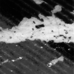 Figure 1. This crack in the image layer of a colour photocopy occurred after folding the paper just twice. Note the splintering of the brittle toner. (magnification x60 approx.)