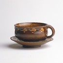 Bernard Leach, cup and saucer, earthenware, height 67mm, width 132mm, about 1920-24. Museum no. C.84, a-1972