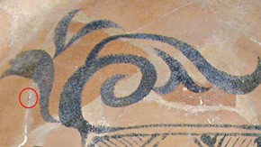 Figure 3. Detail from bowl during cleaning showing the incorrectly painted blue design, the circle indicates the small area of the original blue decoration that emerged after removing the old restoration material (Photography by Hanneke Ramakers)