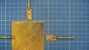 Figure 1. Detail of one of the soldered removable arms and the corresponding notch cut into the back plate (Photography by Hannah Brown)