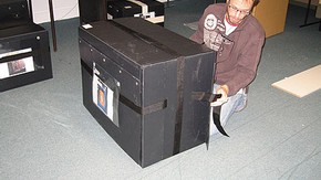 Figure 6. The two pieces of webbing running horizontally around the box were joined and then tightened, ensuring the side flaps were pulled tight (Photography by Merryl Huxtable)