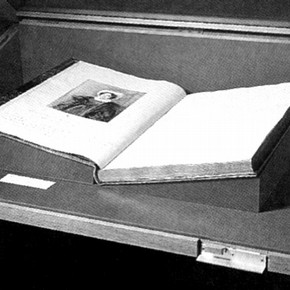 Figure 1. Book support made of museum board covered in the same cloth as the case lining, during installation. Photography by V
