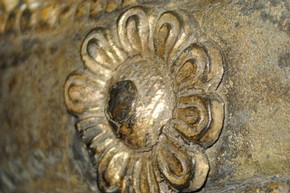 Figure 4 - Detail of a repousséd copper flower attached to the front of the gilded brass belt. Photography by Diana Heath