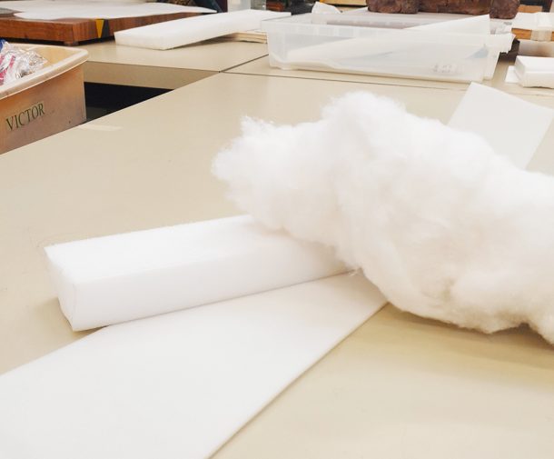 Fluffy white cotton roll and hard plastic foam plastozote on a table