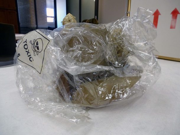 T.112-1939, poke bonnet, enclosed in a plastic bag due to its toxicity