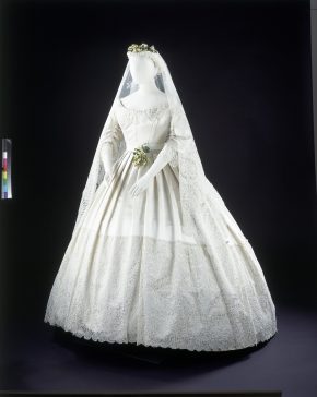 White satin wedding dress trimmed with Honiton lace, 1865