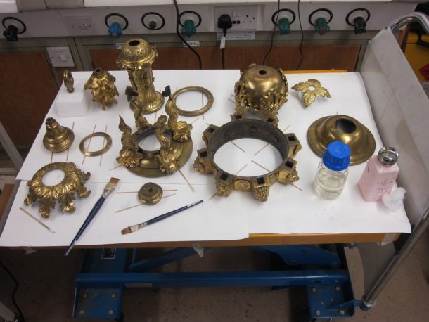 Just some of the disassembled chandelier pieces. The bottles on the trolley contain lacquer and acetone