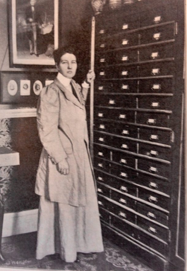 Enthoven at home with cabinets holding her collected materials, about 1909. 