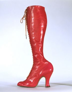 T.321-1970 Left boot from a pair of ladies' red leather, calf-length, laced boots with cotton twill, plain woven silk, metal and shoe string; retailed by National Shoe Stores, London; made in Belgium; retailed in London; c.1920.