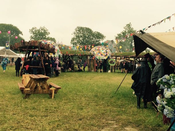 Festival-goers sheltering from the rain on Friday
