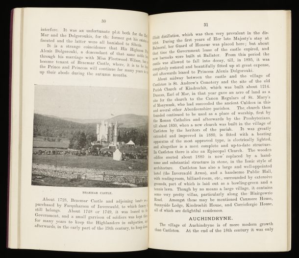 A double page printed spread of text about Braemar Castle and the beginnings of a section about Auchindryne. There is an black and white photographic illustration of Braemar Castle and surrounding countryside and Highlands in the background.