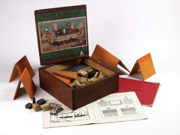 A box of building blocks open to show the contents and instruction booklets