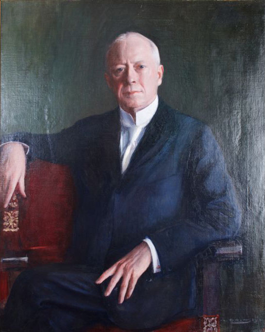 Portrait of a man seated. He has grey hair and a white tie; his hand rests on his lap