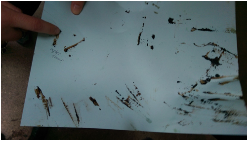 Scraping the melted amber onto paper to check the consistency as the black appearance looked like it had burnt