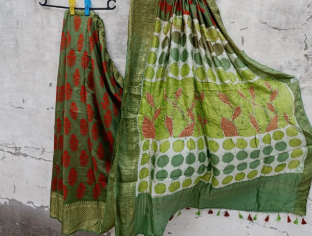 Two saris hanging against a wall