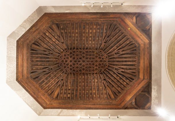 An unpainted latticed ceiling without gilding or decoration