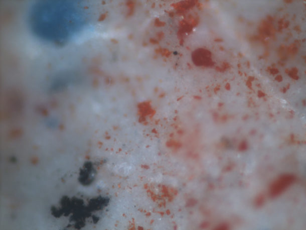 Figure 3. Mixture of pigments, viewed under an optical microscope, from the skin of the Virgin Mary, containing white, blue, red, orange and black pigments. Photography by Lucia Burgio © Victoria and Albert Museum.