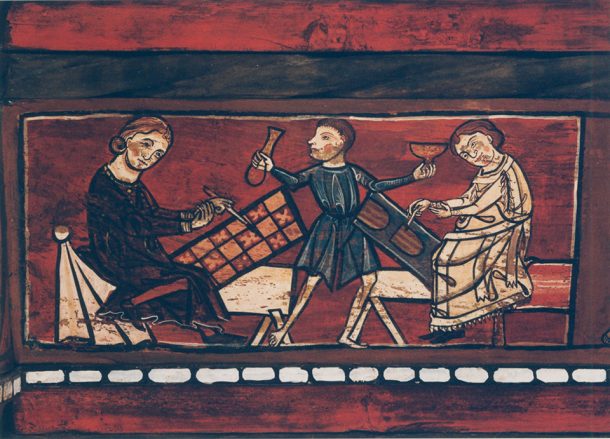 Three medieval figures painting in a workshop