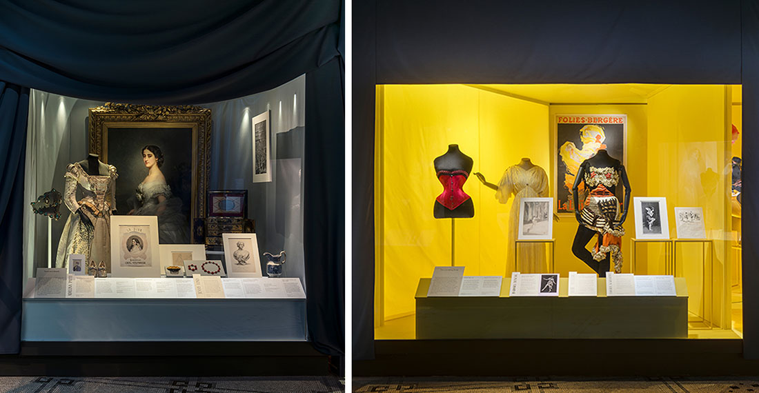 Objects in display cases, backed by brightly coloured fabric