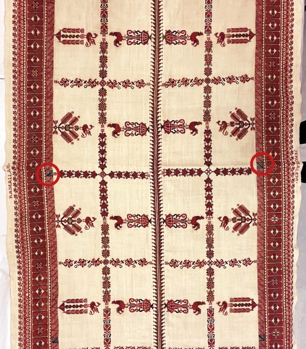 Embroidered cloth with pattern showing cockerels and floral motifs