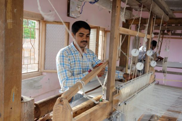 A man working on a wooden loom