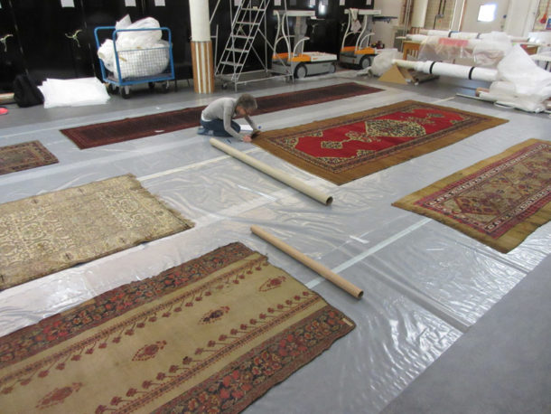 The author examining carpets in store at Blythe House 