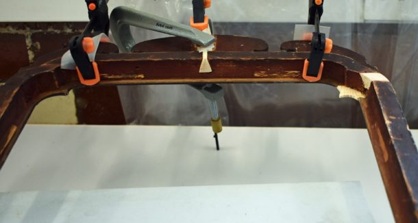 Figure 4. Top frame cresting replaced viewed from behind the frame. Also front and back new wood visible on the top right
