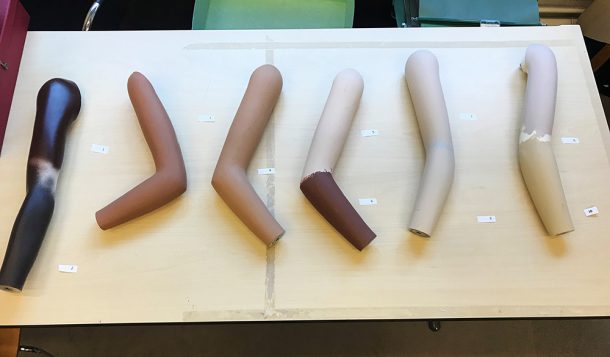 Table with mannequin arms in different skin tones