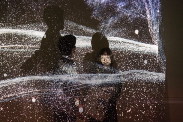 Visitors engaging with Mirage, an immersive audio-visual installation by Fatimah Nader Al-abed.