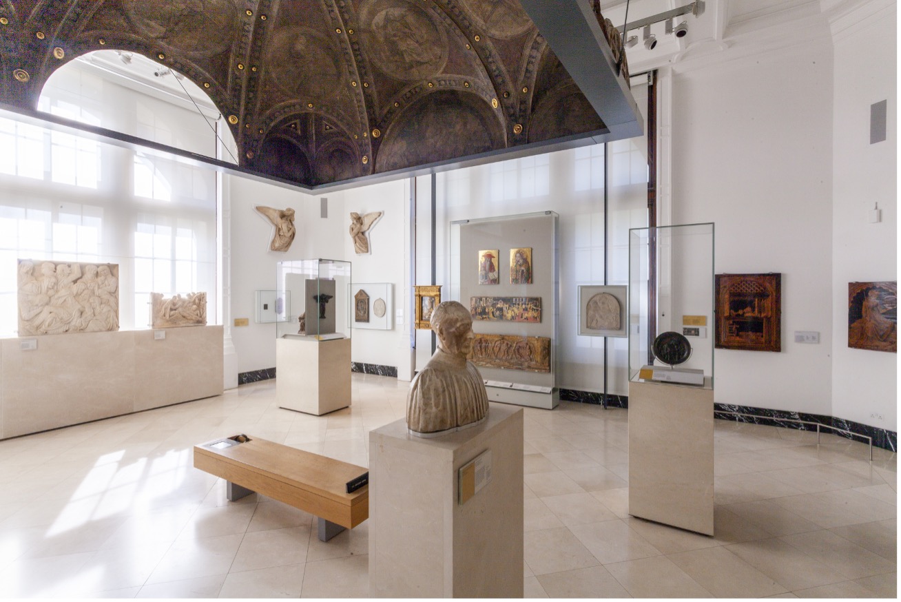 Room in the museum showing sculpture and paintings