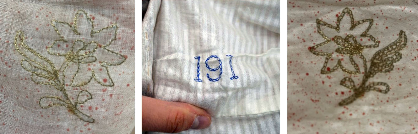 Details of embroidery on the jama – two flowers and the number '191'