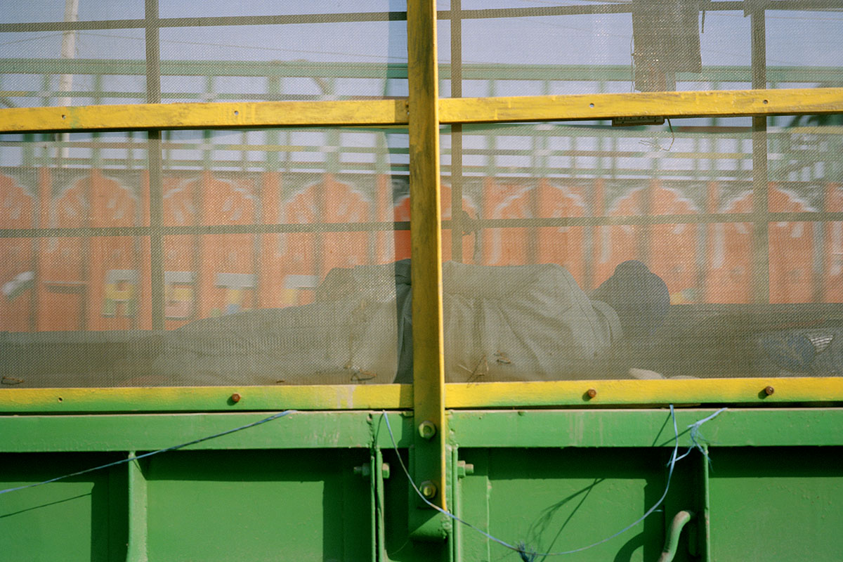 A man sleeping behind a net