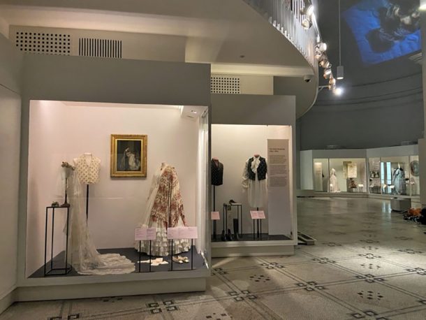 A view of the V&A Fashion Gallery with showcases showing objects
