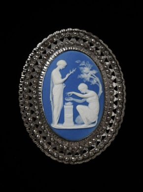 Blue medallion with white figures, one of them kneeling