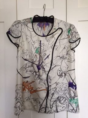 White silk short-sleeved top. The silk printed with a painterly design of fairies playing musical instruments.