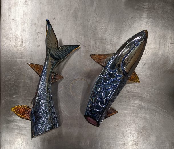 A glass sculpture of a fish in two halves