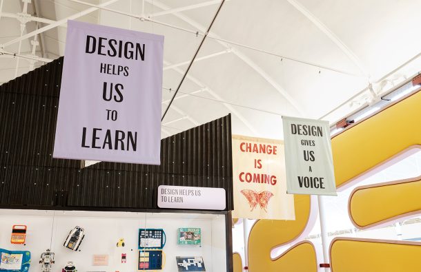 Banners hanging from the ceiling of Young V&A that say 'change is coming', 'design helps us learn' and 'design gives us a voice'