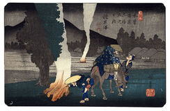 Travellers lighting their pipes by a camp fire