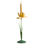 A green and yellow candlestick in the form of a spring Iris flower. A yellow candle is placed on its top.