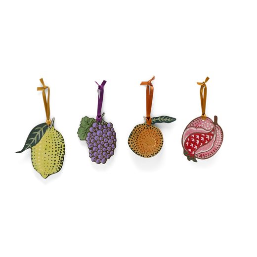 Four woodcut fruit decorations. From left to right: a yellow lemon, purple grapes, an orange clementine, and a pink pomegranate.