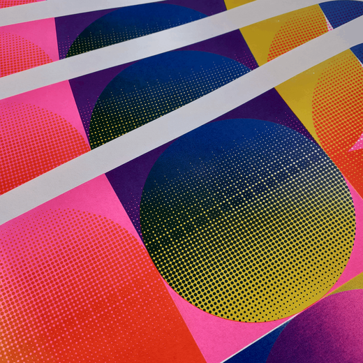 Detail of a risograph print featuring colourful geometric shapes in hot pink, yellow and blue.