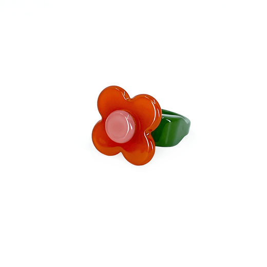 An orange and green flower shaped ring.