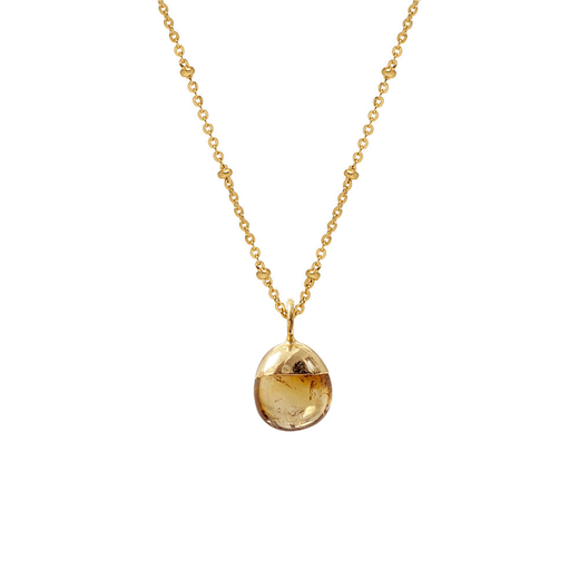 Gold chain necklace with a deep yellow stone pendant.
