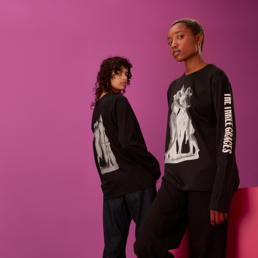 A pair of models showcase the different designs on front and back of the three graces tee